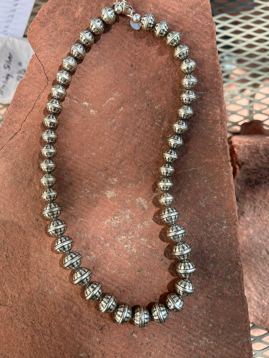Navajo Pearl style sterling silver necklace with stamped arrow design