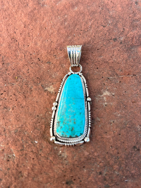 Samuel Yellowhair, Navajo made turquoise and sterling silver pendant.  2” tall. NM156