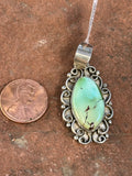 Navajo handcrafted sterling silver and genuine turquoise, pendant, 1.65” top to bottom.  LZ081