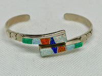 Navajo handcrafted sterling silver bracelet with inlaid Lab Opal.  LZ824