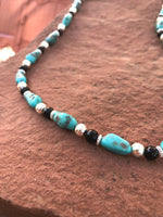 Genuine Campitos Turquoise with black onyx and sterling silver beads in a 22” length.  SR120