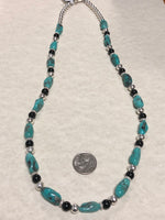 Genuine Campitos Turquoise with black onyx and sterling silver beads in a 22” length.  SR120