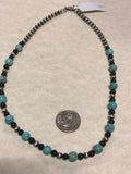 Genuine Campitos Turquoise with black onyx and sterling silver beads in a 22” length.  SR120